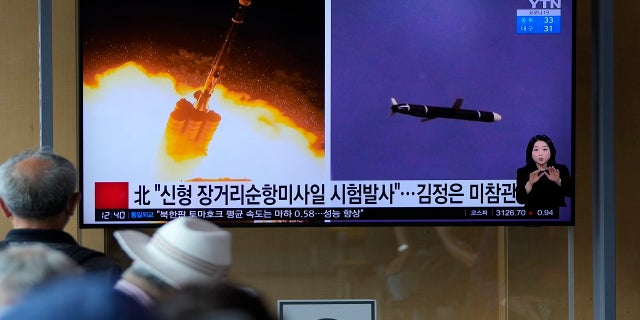 People watch a TV screen showing a news program reporting about North Korea's long-range cruise missiles tests with images in Seoul, South Korea, on Monday. (Associated Press)