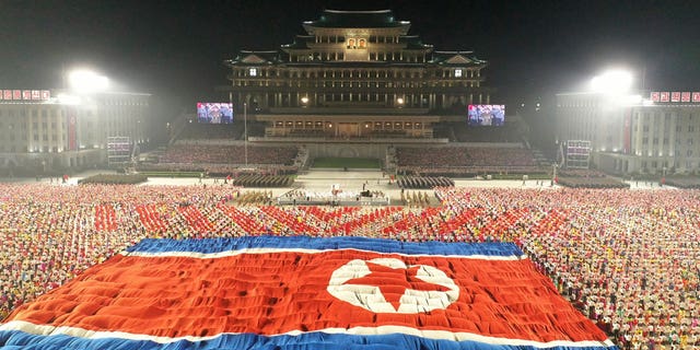 A huge North Korean flag is displayed during a celebration of the nation’s 73rd anniversary at Kim Il Sung Square in Pyongyang, North Korea, early Thursday, Sept. 9, 2021.
