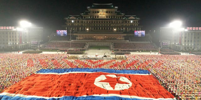 In this photo provided by the North Korean government, a huge North Korean flag is displayed during a celebration of the nation’s 73rd anniversary at Kim Il Sung Square in Pyongyang, North Korea, early Thursday, Sept. 9, 2021. (Korean Central News Agency/Korea News Service via AP)