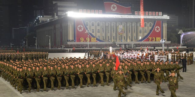 In this photo provided by the North Korean government, North Korean soldiers parade during a celebration of the nation’s 73rd anniversary that was overseen by leader Kim Jong Un, at Kim Il Sung Square in Pyongyang, North Korea, early Thursday, Sept. 9, 2021. Independent journalists were not given access to cover the event depicted in this image distributed by the North Korean government. The content of this image is as provided and cannot be independently verified. Korean language watermark on image as provided by source reads: "KCNA" which is the abbreviation for Korean Central News Agency. (Korean Central News Agency/Korea News Service via AP)