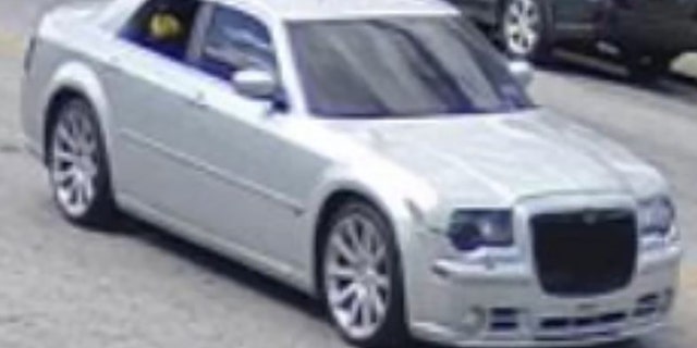 The suspect vehicle was described as a silver Chrysler 300 SDN with dark tinted windows, including the windshield and rear window, a custom black grille and colored headlights front and rear.
