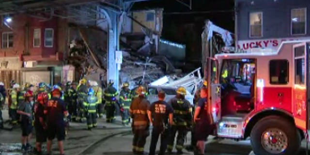 Philadelphia firefighters and other emergency responders gather at the scene of Thursday night's building collapse in the city's Kensington neighborhood. (FOX 29, Philadelphia)