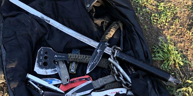 Police said they found the suspect in possession of 15 weapons, including a sword, ax, several knives and a slingshot.