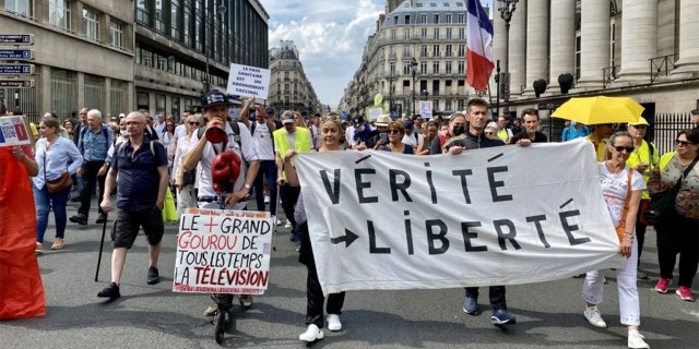 PARIS, FRANCE - SEPTEMBER 4: People attend a protest against Covid-19 restrictions, government's decision of vaccination obligation and Covid-19 health license application brought to some professions in order to combat the new type of coronavirus (Covid-19) in Paris, France on September 4, 2021. (Photo by Yusuf Ozcan/Anadolu Agency via Getty Images)