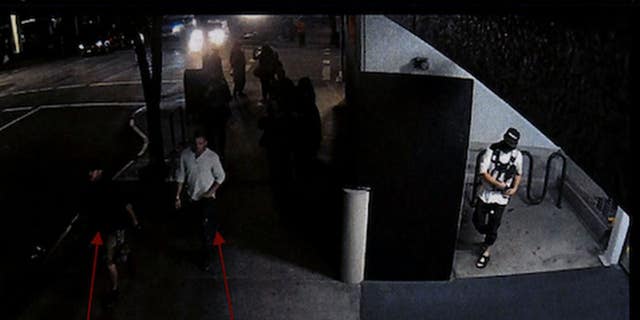 Security camera footage from Aug. 29, 2020, shows Michael Reinoehl in an alcove of a Portland, Oregon, parking garage while Aaron Danielson and a friend walk by, according to police. (Portland Police Bureau)