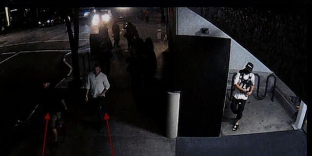 Security camera footage from Aug. 29, 2020, shows Michael Reinoehl in an alcove of a Portland, Oregon, parking garage while Aaron Danielson and a friend walk by, according to police. (Portland Police Bureau)