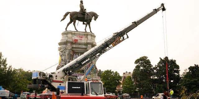 Crews prepare one of the country's largest remaining monuments to the Confederacy, a towering statue of Confederate General Robert E. Lee on Monument Avenue, Wednesday, Sept. 8, 2021, in Richmond, Va. 