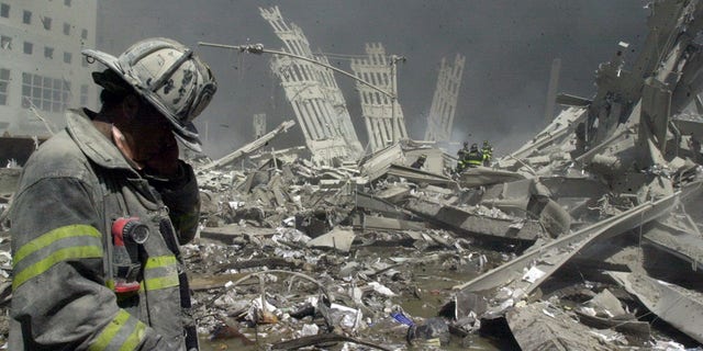 Firefighter walks through the rubble of the World Trade Center following the 9/11 terrorist attacks.