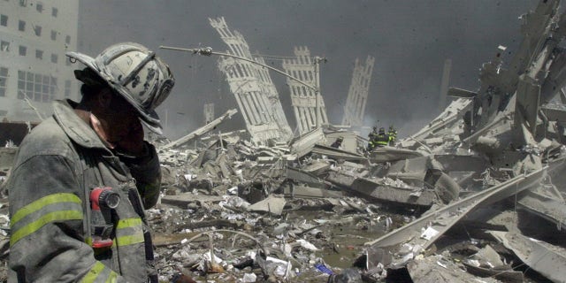 Firefighter walks through the rubble of the World Trade Center after it was struck by a commercial airliner in a terrorist attack. 