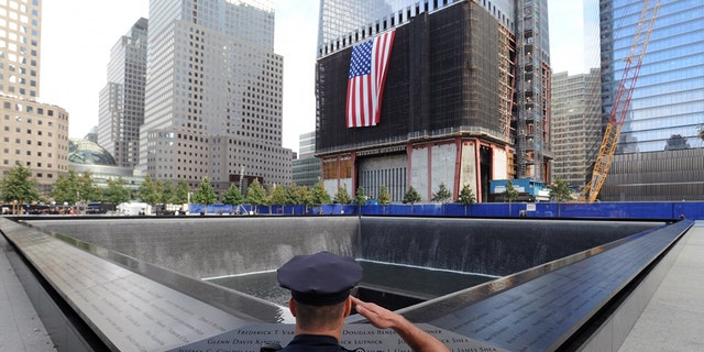 NEW YORK, NY - SEPTEMBER 11:  New York City Police Officer Danny Shea, a military vet, salutes at the North pool of the 9/11 Memorial during the tenth anniversary ceremonies of the September 11, 2001 terrorist attacks at the World Trade Center site, September 11, 2011 in New York City.  (Photo by David Handschuh-Pool/Getty Images)