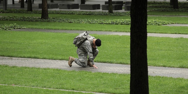 Army Reserve Sergeant.  Edwin Morales kneels in memory of his late friend Ruben Correa, a firefighter killed in the 9/11 attacks, at the National 9/11 Memorial. "From the literal ashes rose hope, unity and a renewed sense of community and country," one religious leader told Fox News Digital.