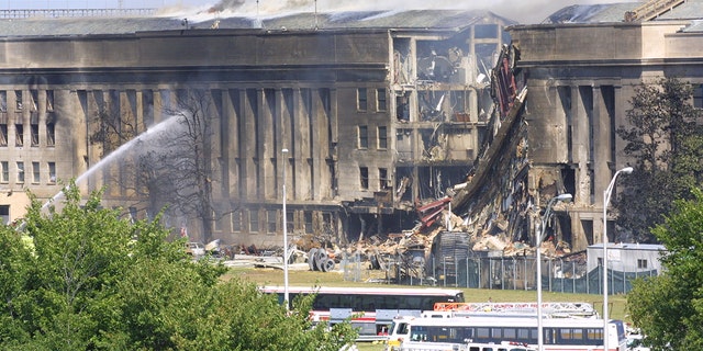 Smoke comes out from the Southwest E-ring of the Pentagon building Sept. 11, 2001 in Arlington, Virginia, after a plane crashed into the building and set off a huge explosion. 