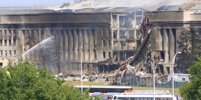 Smoke comes out from the Southwest E-ring of the Pentagon building Sept. 11, 2001 in Arlington, Virginia, after a plane crashed into the building and set off a huge explosion.