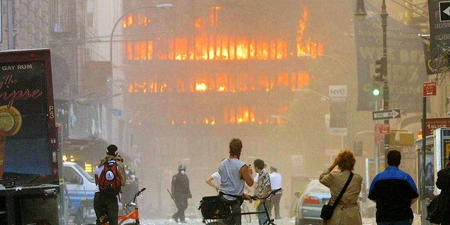 People walk in the street in the area where the World Trade Center buildings collapsed Sept. 11, 2001. 