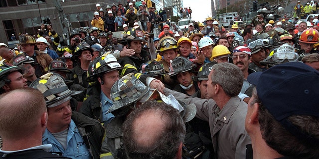 President George W. Bush greets firefighters, police and rescue workers as he visits the site of the terrorist attack on the World Trade Center in New York on September 14, 2001.  Image courtesy of the National Archives.