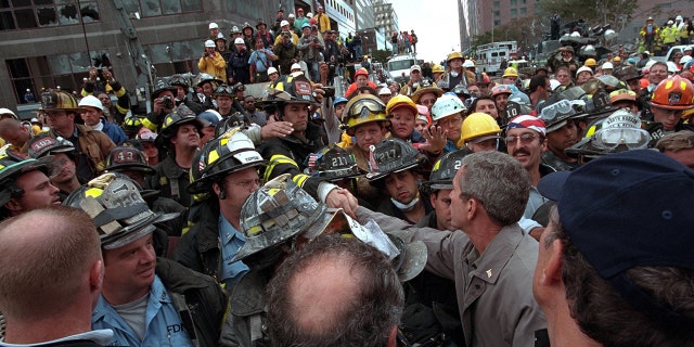President George W. Bush greets firefighters, police and rescue workers as he visits the site of the terrorist attack on the World Trade Center in New York on September 14, 2001. Image courtesy of the National Archives.