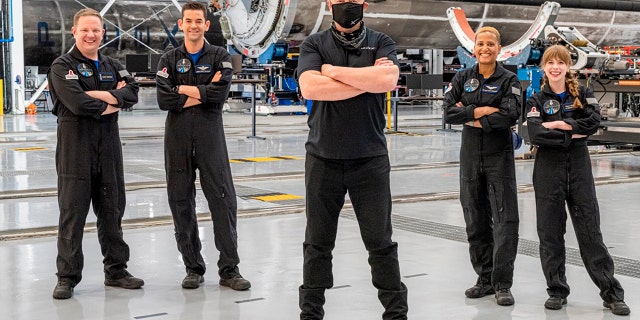 In this photo provided by Inspiration4, Elon Musk, front center, poses with the all-amateur crew before departure to Launch Complex 39A for a launch into space, Wednesday, Sept. 15, 2021, at Kennedy Space Center, in Cape Canaveral, Fla. Standing behind Musk, from left to right, are Chris Sembroski, Jared Isaacman, Sian Proctor and Hayley Arceneaux.