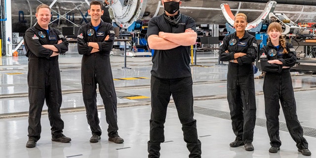 In this photo provided by Inspiration4, Elon Musk, center, poses with the all-amateur crew before departing to Launch Complex 39A for a space launch on Wednesday, September 15, 2021, at the Kennedy Space Center, Cape Town Canaveral, Florida.  Standing behind Musk, left to right, are Chris Sembroski, Jared Isaacman, Sian Proctor and Hayley Arceneaux. 