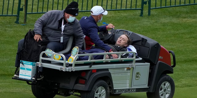 Actor Tom Felton is being helped after collapsing on the 18th hole during a practice day at the Ryder Cup at Whistling Straits Golf Course on Thursday, September 23, 2021, in Sheboygan, Wis.  (Associated Press)