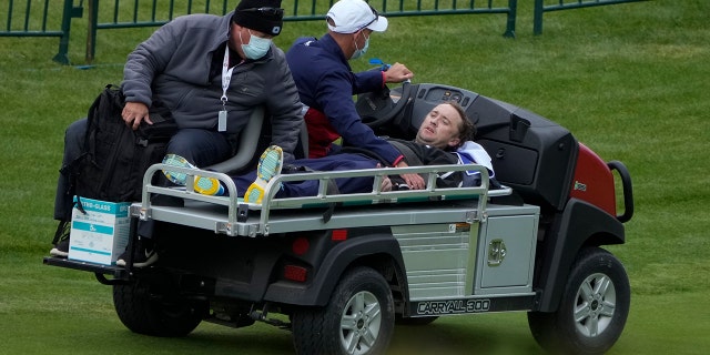 Actor Tom Felton is helped after collapsing on the 18th hole during a practice day at the Ryder Cup at the Whistling Straits Golf Course Thursday, Sept. 23, 2021, in Sheboygan, Wis. (Associated Press)