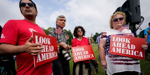 Protesters hold placards near members of the media ahead of a rally near the United States Capitol in Washington on Saturday, September 18, 2021. The rally was planned by allies of former President Donald Trump and was aimed at supporting the so- saying "political prisoners" of the January 6 uprising at the United States Capitol.  (AP Photo / Brynn Anderson)
