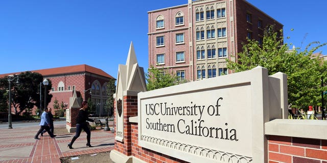  This March 12, 2019, file photo shows the University Village area of the University of Southern California, in Los Angeles. The first trial in the "Operation Varsity Blues" college admissions bribery scandal will begin this week, Wednesday, Sept. 8, 2021, with the potential to shed light on investigators' tactics and brighten the spotlight on a secretive school selection process many have long complained is rigged to favor the rich. (AP Photo/Reed Saxon, File)