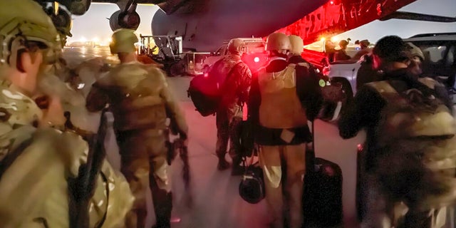 In this image provided by the U.S. Army, paratroopers attached to the 82nd Airborne Division and others are preparing to board a C-17 cargo plane at Hamid Karzai International Airport in Kabul, Afghanistan. 