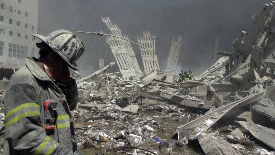 On 9/11, a firefighter walks through the rubble of the World Trade Center after it was struck by a commercial airliner in a terrorist attack