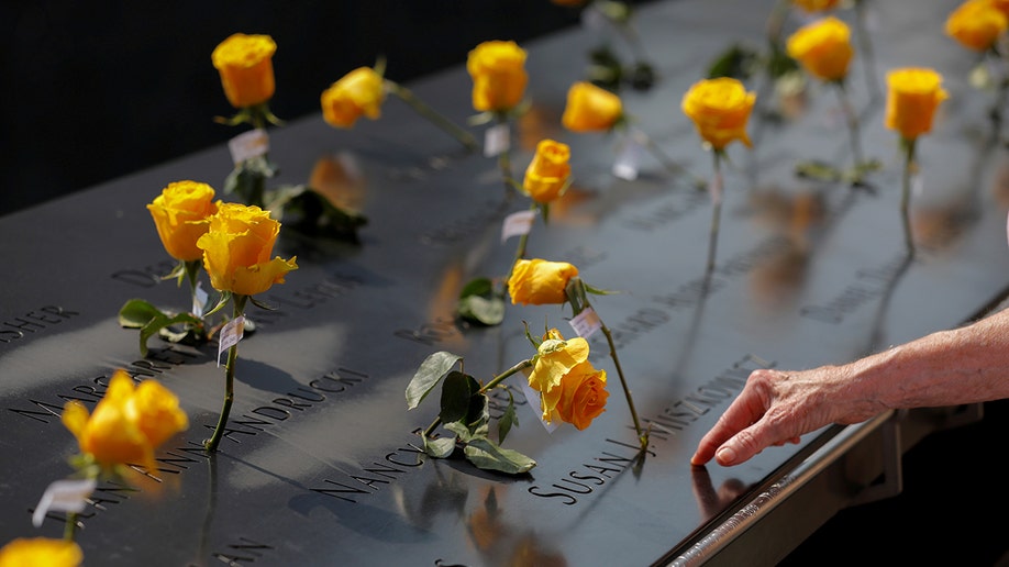Flowers are seen in the names of victims at the National September 11 Memorial & Museum a month before the 20th anniversary of the September 11 attacks in Manhattan, NYC