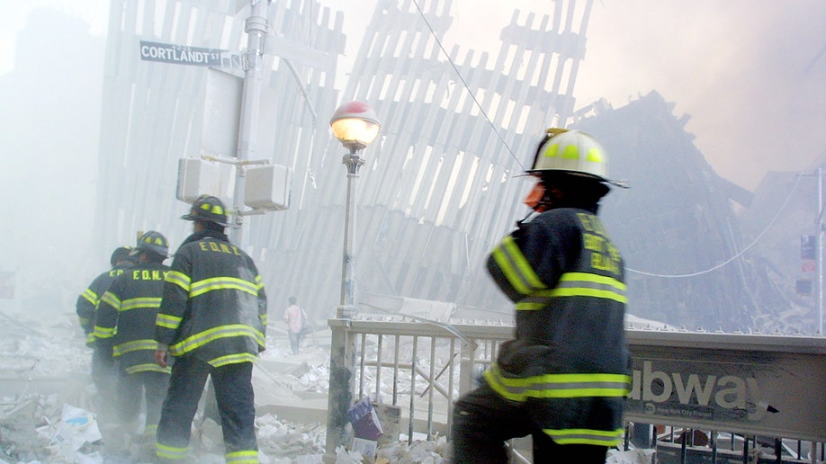 Firemen arrive on the scene after the collapse of the first World Trade Center Tower 9/11, 2001 in New York. 
