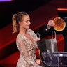 Host Norm Macdonald removes a pancake from a spoof "swag bag" at the 2016 Canadian Screen Awards in Toronto, Ontario March 13, 2016. 