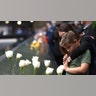 A young boy and his mother looks down into the South Pool during observances on Sept. 11, 2018, held on the 17th year since the September 11, 2001, terror attacks at the annual ceremony at the Ground Zero memorial site. (TIMOTHY A. CLARY/AFP via Getty Images)