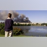 An unidentified motorist watches smoke billow from the Pentagon in Washington, D.C., Sept. 11, 2001, after an airplane crashed into it. (LUKE FRAZZA/AFP via Getty Images)
