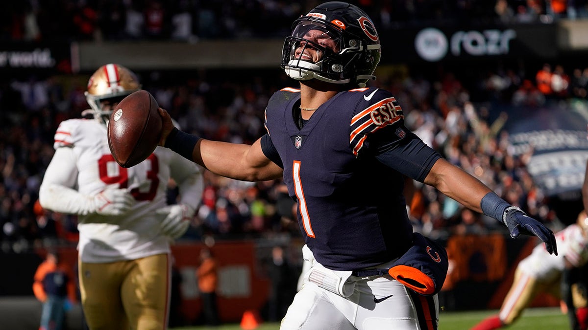Chicago Bears quarterback Justin Fields begins to celebrate his touchdown against the San Francisco 49ers during the second half Sunday, Oct. 31, 2021, in Chicago.