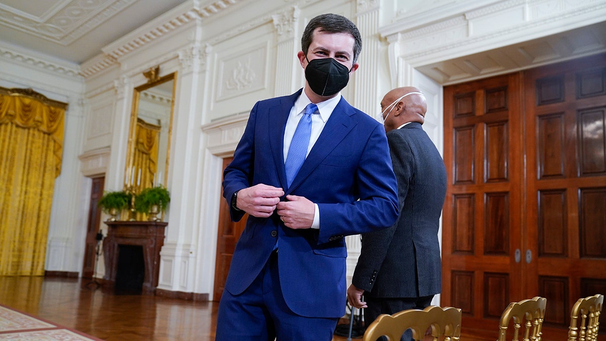 Transportation Secretary Pete Buttigieg arrives to attend an event on the global supply chain bottlenecks during in the East Room of the White House, Wednesday, Oct. 13, 2021, in Washington. (AP Photo/Evan Vucci)