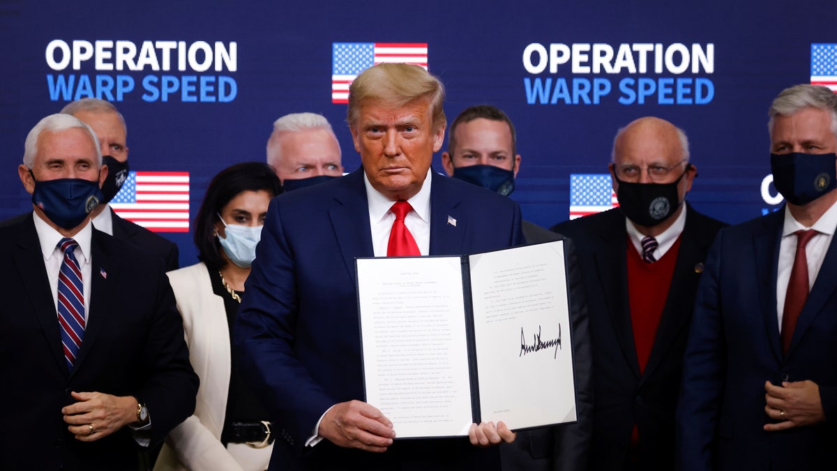 U.S. President Donald Trump signs an executive order on vaccine distribution during an Operation Warp Speed Vaccine Summit at the White House in Washington, U.S., December 8, 2020. REUTERS/Tom Brenner