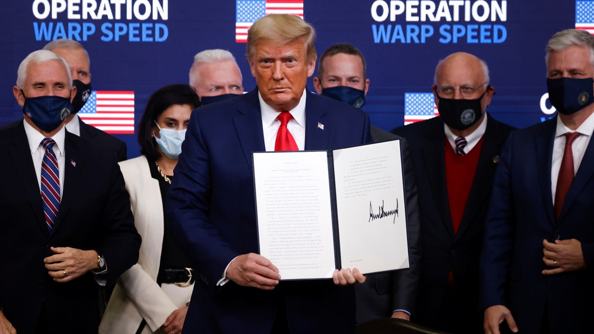 U.S. President Donald Trump signs an executive order on vaccine distribution during an Operation Warp Speed Vaccine Summit at the White House in Washington, U.S., December 8, 2020. REUTERS/Tom Brenner