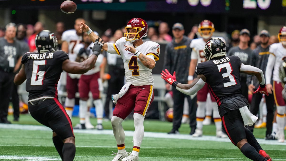 Washington Football Team quarterback Taylor Heinicke (4) throws a touchdown pass against the Atlanta Falcons during the fourth quarter at Mercedes-Benz Stadium. 