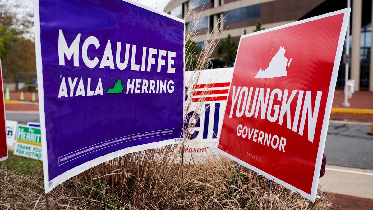 Campaign signs for Democrat Terry McAuliffe and Republican Glenn Youngkin stand together on the last day of early voting in the Virginia gubernatorial election in Fairfax, Va., Oct. 30, 2021. REUTERS/Joshua Roberts