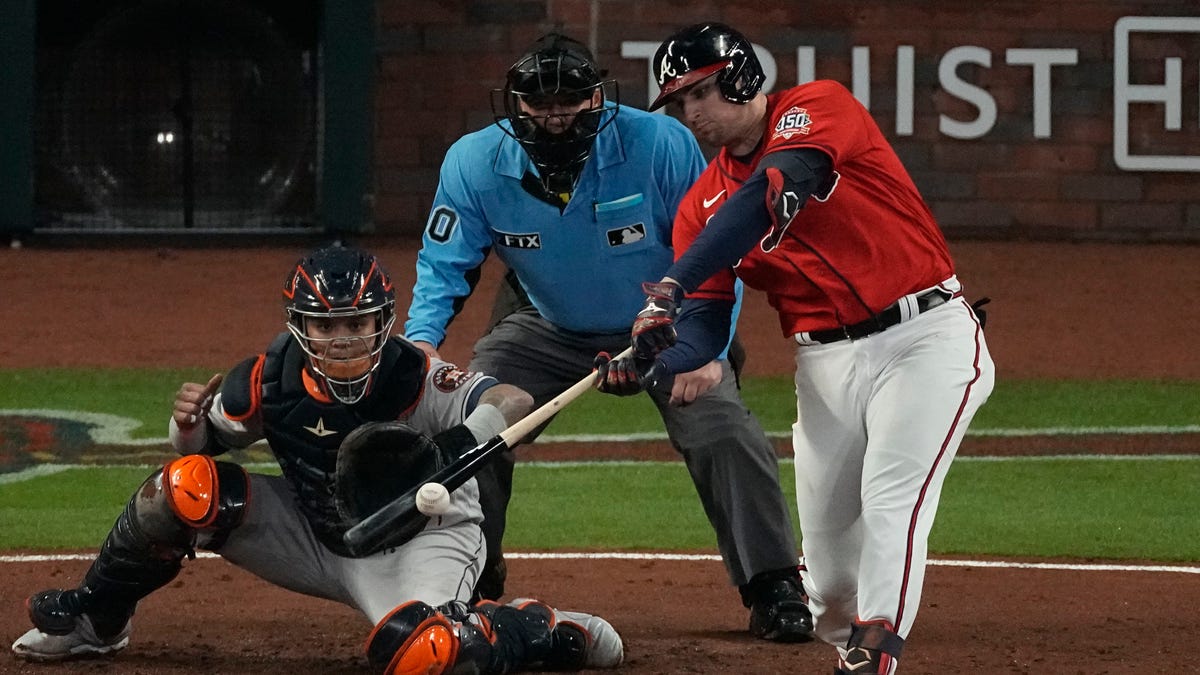 Atlanta Braves' Austin Riley hits a RBI-double during the third inning in Game 3 of baseball's World Series between the Houston Astros and the Atlanta Braves Friday, Oct. 29, 2021, in Atlanta.
