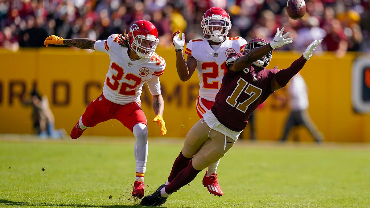 Washington Football Team wide receiver Terry McLaurin (17) reaches out but misses the catch as he covered by Kansas City Chiefs free safety Tyrann Mathieu (32) and cornerback Mike Hughes (21) during the first half of an NFL football game, Sunday, Oct. 17, 2021, in Landover, Md.