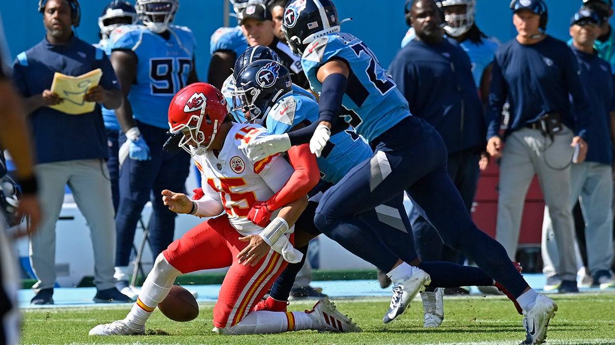 Kansas City Chiefs quarterback Patrick Mahomes (15) fumbles the ball as he is hit by Tennessee Titans free safety Kevin Byard (31) in the first half of an NFL football game Sunday, Oct. 24, 2021, in Nashville, Tennessee. The Titans recovered the ball. 