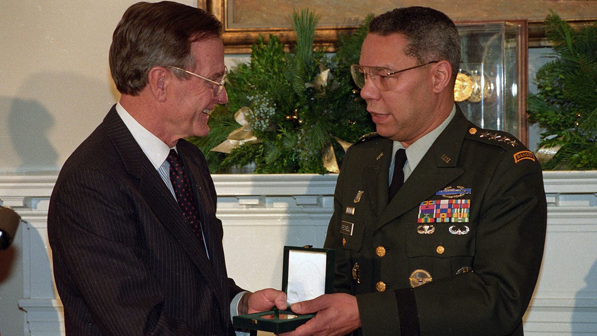 President Bush presenting Joint Chiefs of Staff Chairman Gen. Colin Powell with a Congressional Gold Medal at the White House in 1992.