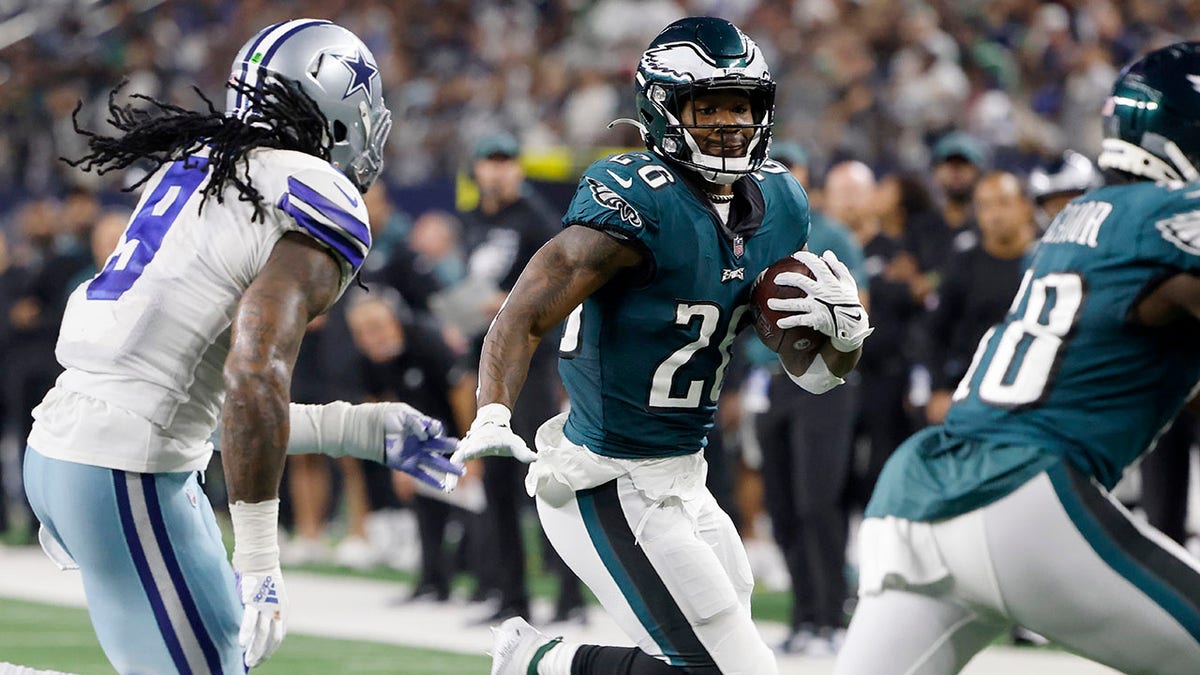 Dallas Cowboys linebacker Jaylon Smith (9) gives chase as Philadelphia Eagles running back Miles Sanders (26) runs the ball in the second half of an NFL football game in Arlington, Texas, Monday, Sept. 27, 2021. (AP Photo/Michael Ainsworth)
