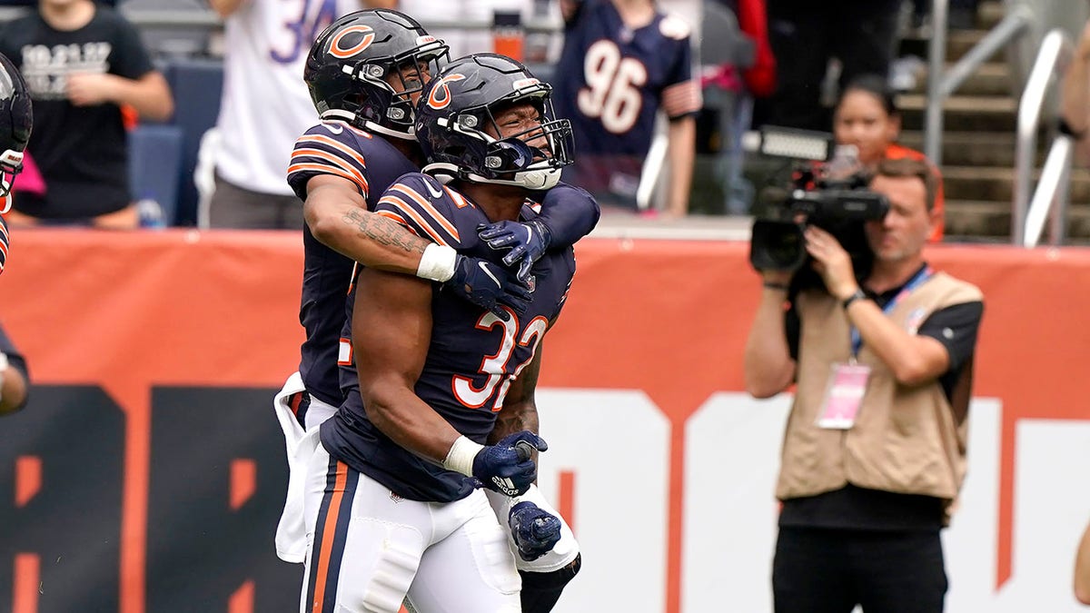 Chicago Bears running back David Montgomery (32) celebrates his touchdown with a teammate during the first half of an NFL football game against the Detroit Lions Sunday, Oct. 3, 2021, in Chicago. (AP Photo/Nam Y. Huh)