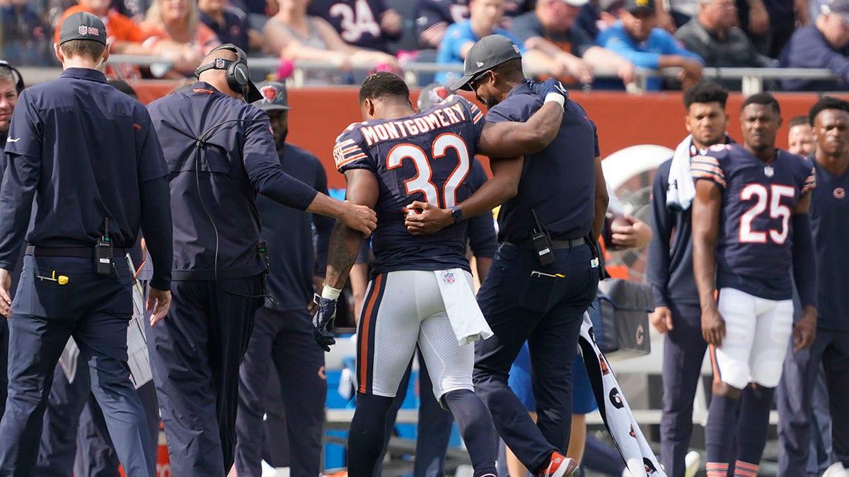 Chicago Bears running back David Montgomery is assisted off the field during the second half of an NFL football game against the Detroit Lions Sunday, Oct. 3, 2021, in Chicago. The Bears won 24-14.