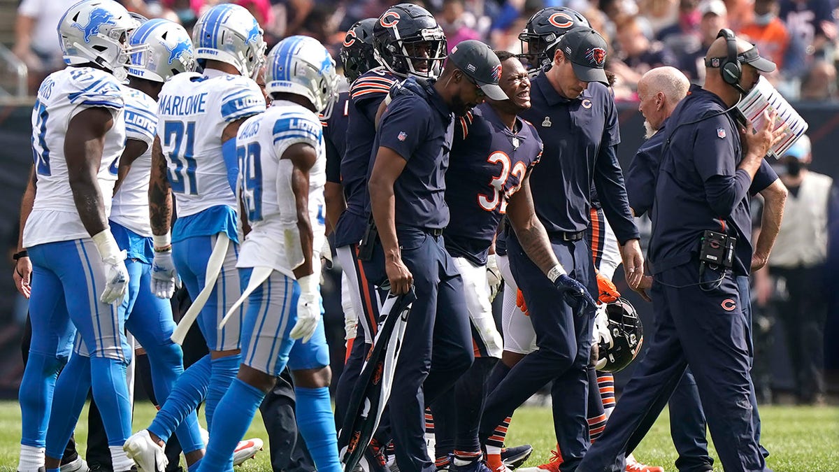 Chicago Bears running back David Montgomery (32) grimaces in pain as he leave the field after being injured during the second half of an NFL football game against the Detroit Lions Sunday, Oct. 3, 2021, in Chicago.