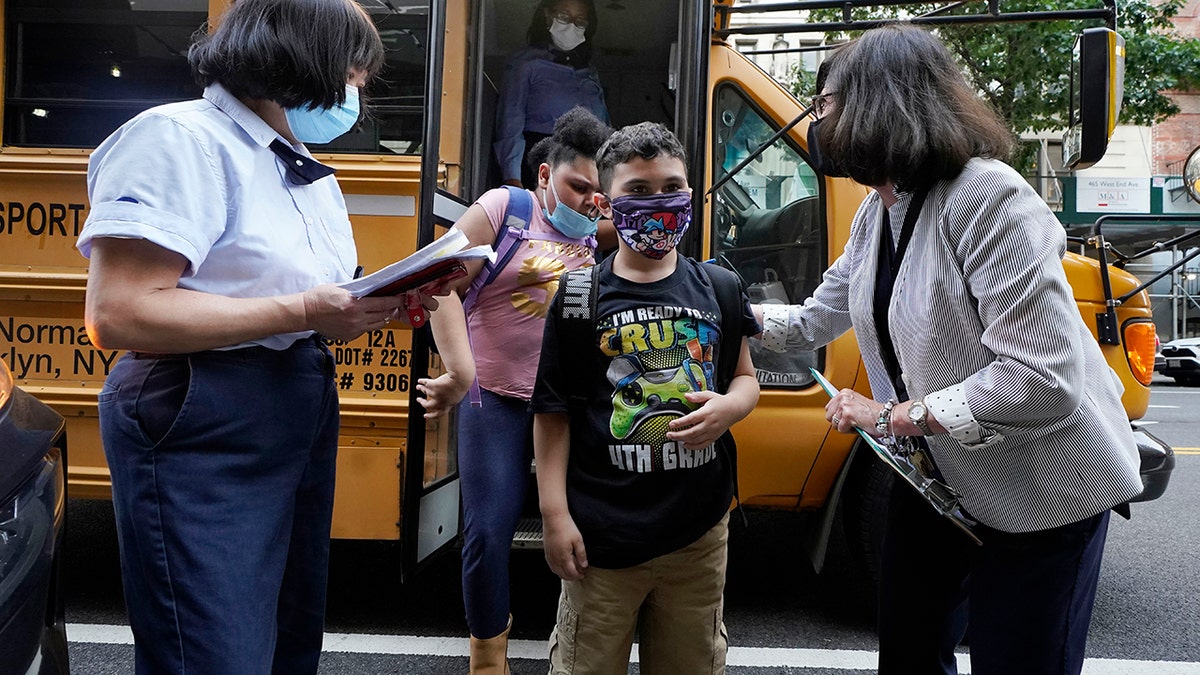 Students are greeted by faculty as they arrive at PS811 in New York, Monday, Sept. 13, 2021.  (AP Photo/Richard Drew, File)