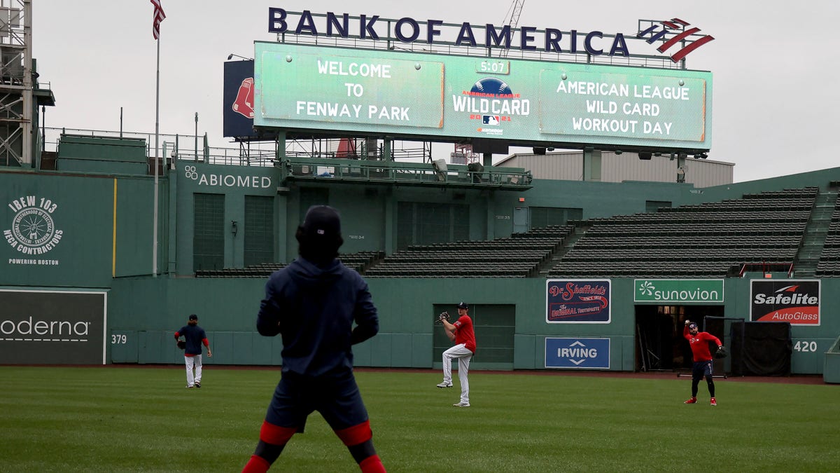 Boston Red Sox players warm up on the field during an American League Wild Card Workout Day at Fenway Park, Monday, Oct. 4, 2021, before Tuesday's American League Wild Card game against the New York Yankees in Boston. (AP Photo/Mary Schwalm)