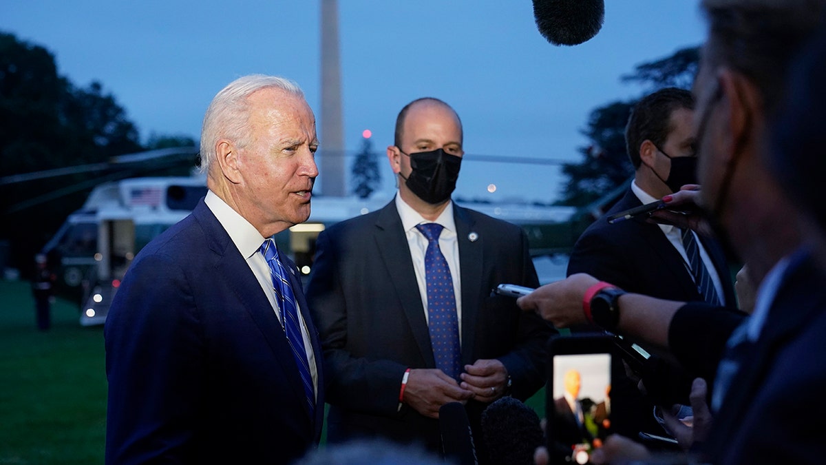 President Joe Biden talks with reporters after returning to the White House in Washington, Tuesday, Oct. 5, 2021, after a trip to Michigan to promote his infrastructure plan. (AP Photo/Susan Walsh)